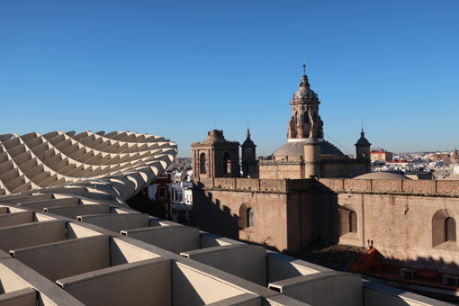 Skline picture in Seville across the modern Settas and an old church