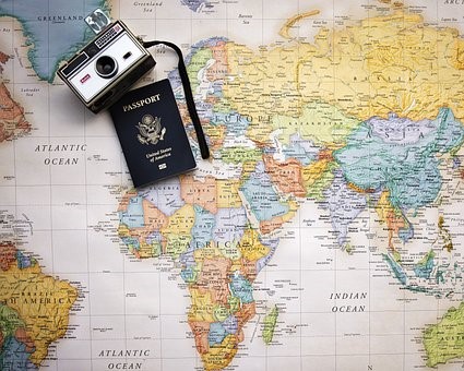 World map with a camera and passport